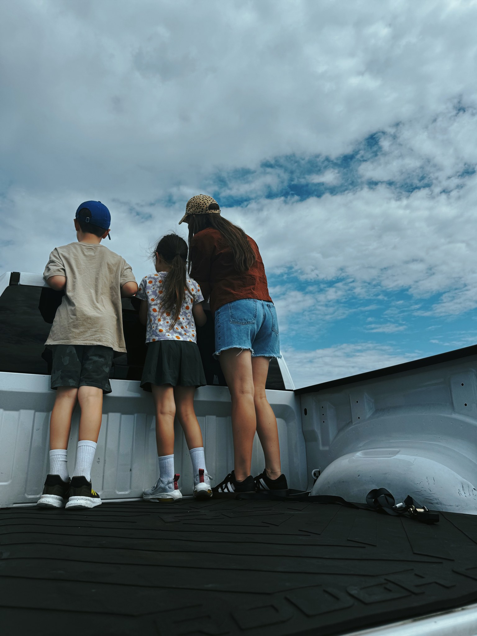 Kids and Kalena looking out from the back of a truck